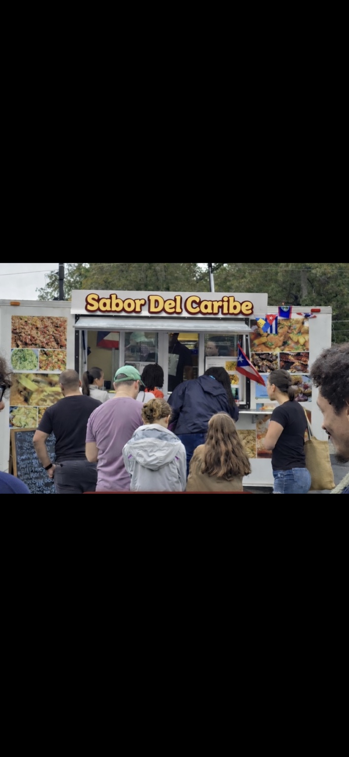 Customers gathered at the Sabor Del Caribe food truck